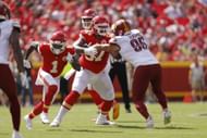 Orlando Brown Jr. #57 blocks Casey Toohill #95 of the Washington Commanders